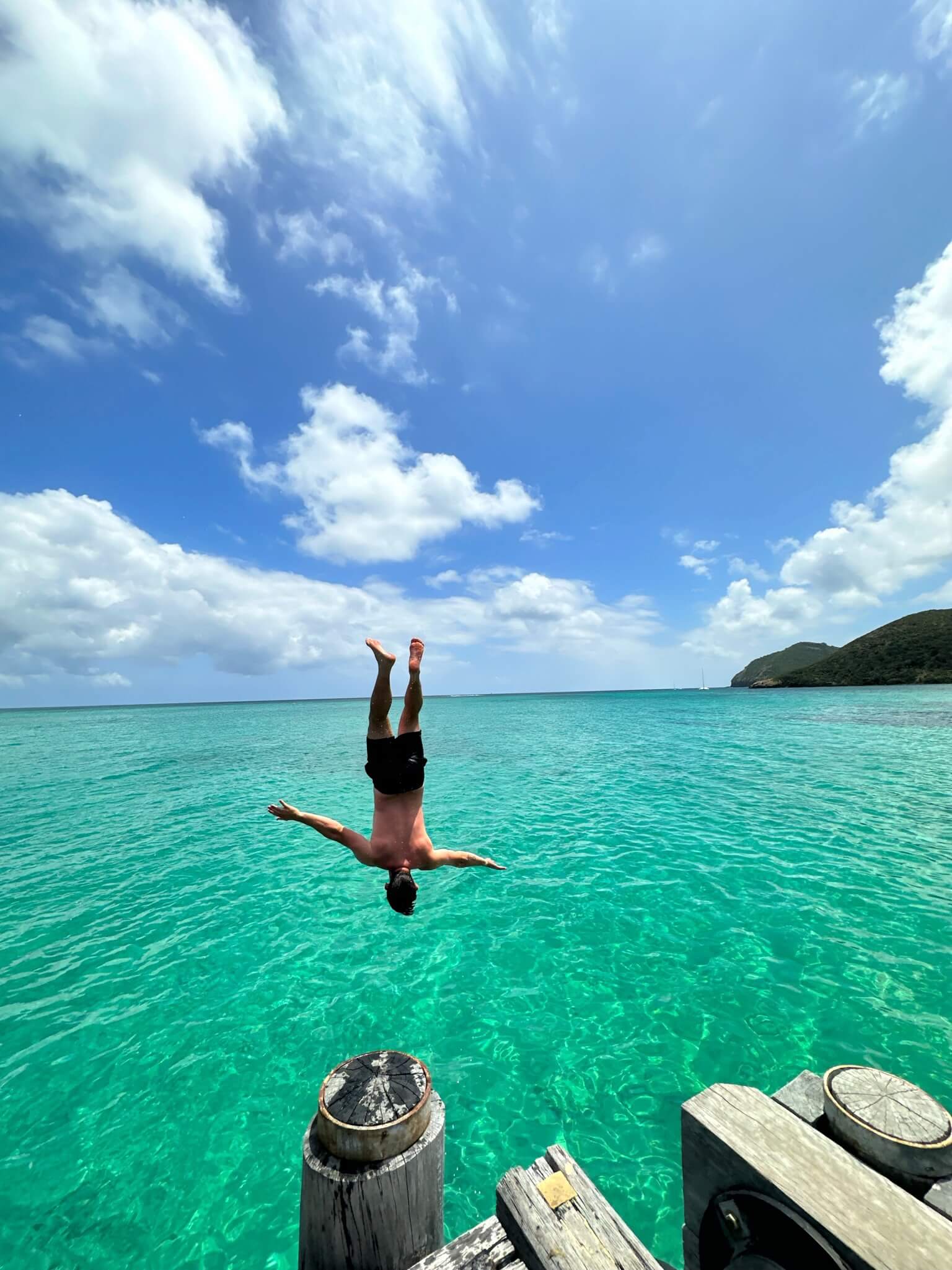 Man backflipping off jetty