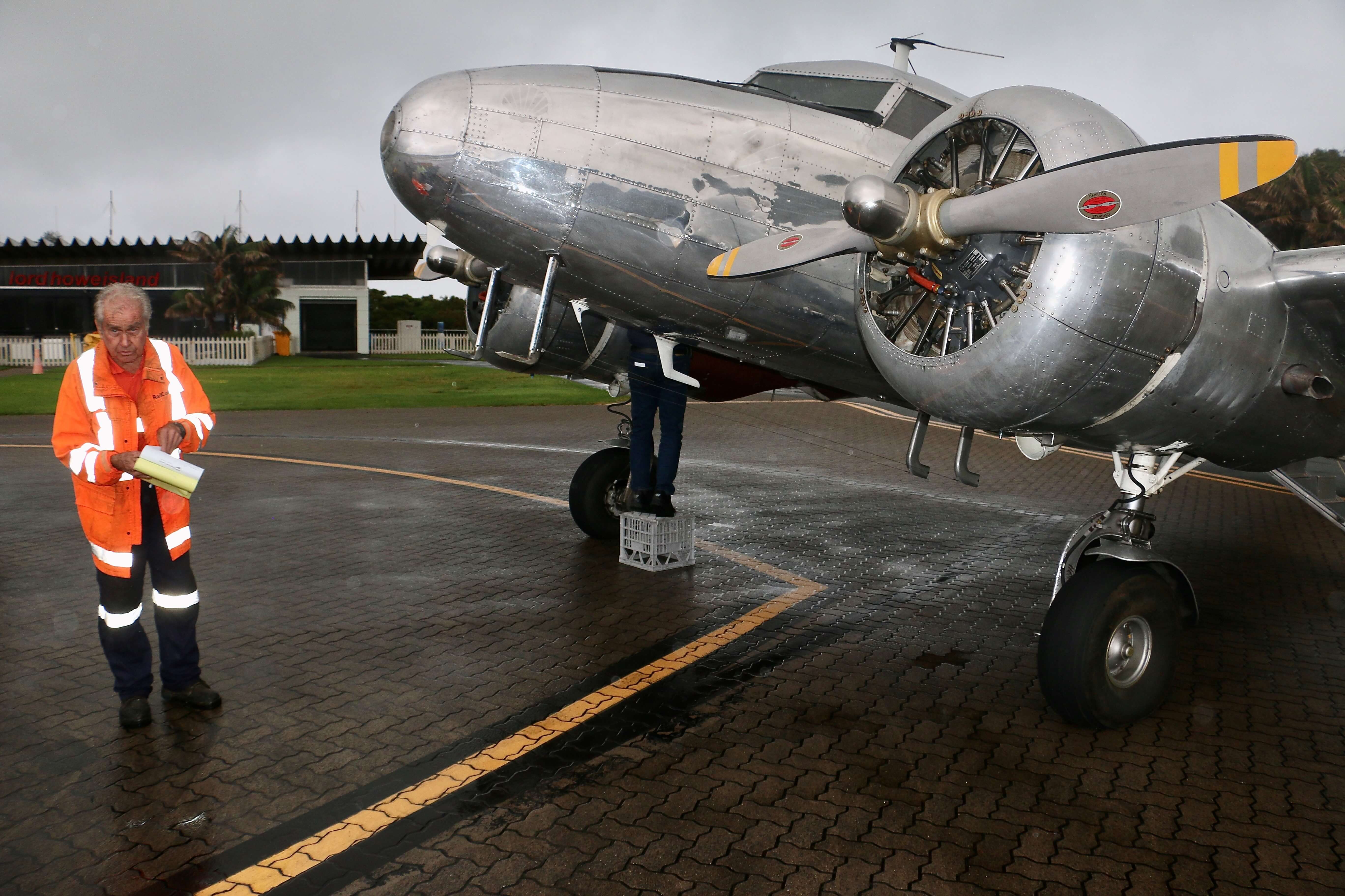 A silver plane being refuelled on Lord Howe Island